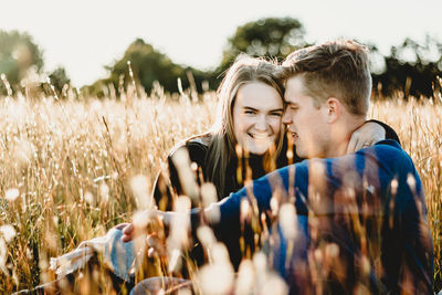 Young couple kissing on field