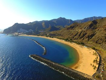 High angle view of beach by rocky mountains