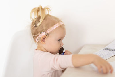 High angle view of girl drawing on paper at home