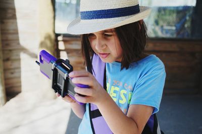 Close-up of girl using mobile phone