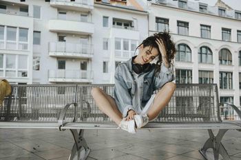 WOMAN IN FRONT OF BUILDINGS