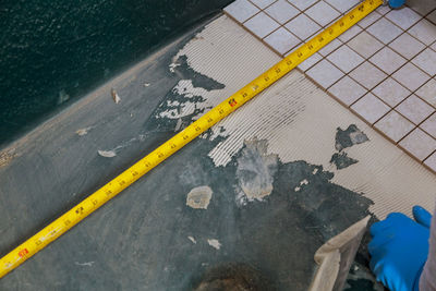 High angle view of yellow arrow sign on water