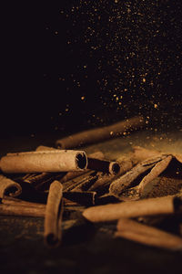 Close-up of rusty metal on table against black background