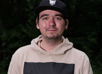 Portrait of young man while standing outdoors