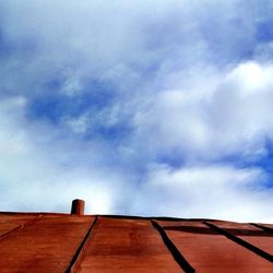 Low angle view of building against cloudy sky