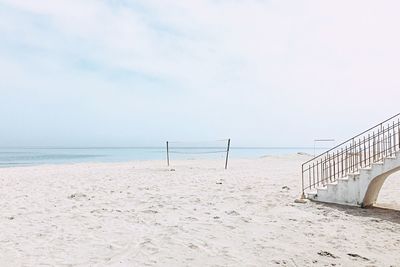 Scenic view of beach against cloudy sky