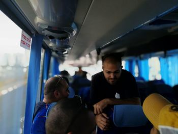 Close-up of friends sitting in bus