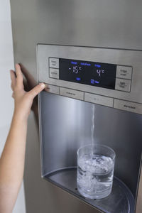 Close-up of hand holding glass of water