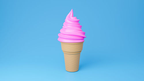 Close-up of ice cream cone against blue background