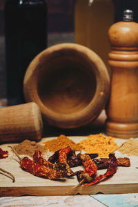 Spices by mortar and pestle on table