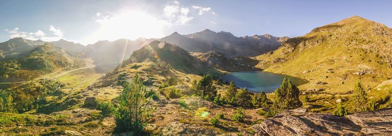 Panoramic view of mountains against sky on sunny day