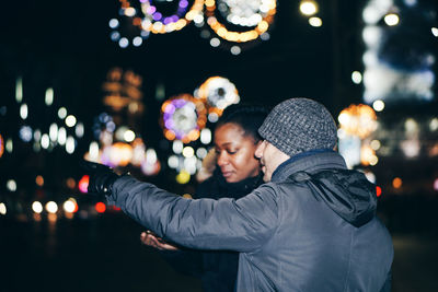 Couple in city at night