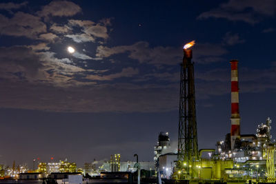 Night view of the moon and oil refineries