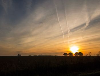 Silhouette landscape against sky during sunset