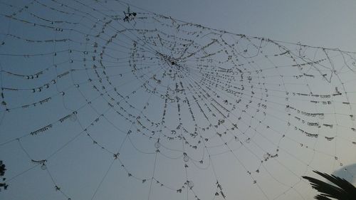 Low angle view of broken glass window against clear sky