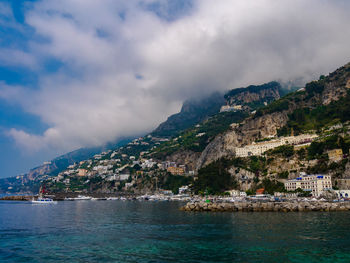 Scenic view of sea and mountains against sky