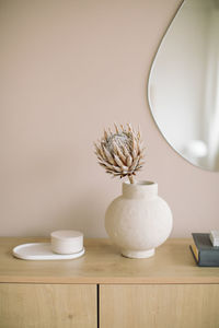 Close-up of pot with plant on table at home