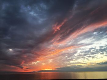 Scenic view of dramatic sky over sea during sunset
