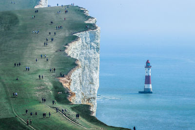 Scenic view of sea by buildings against sky