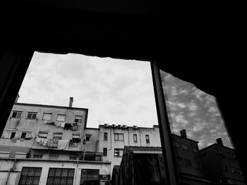 Low angle view of building against cloudy sky