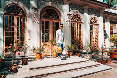 Man standing outside temple against building