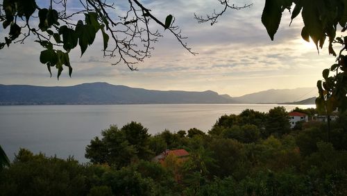 Scenic view of lake against sky at sunset