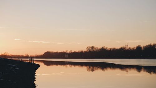 Scenic view of lake against sky during sunset