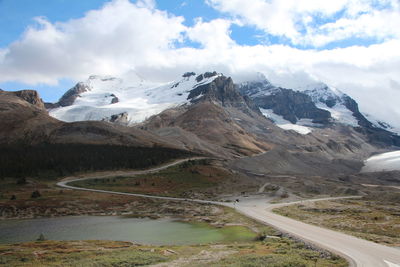 Scenic view of mountains against cloudy sky