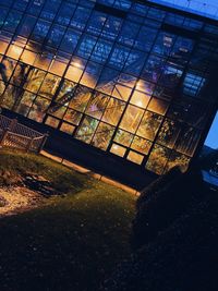 Low angle view of glass building against sky