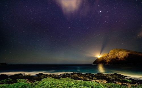 Scenic view of sea against sky at night