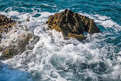 High angle view of rocks in sea