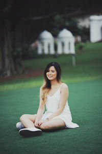 Portrait of a smiling young woman sitting outdoors