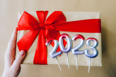 Cropped hand of woman holding gift