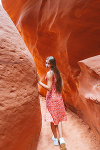 Rear view of woman standing on rock