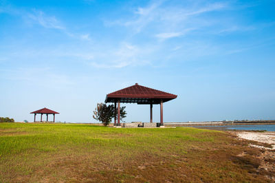 Lifeguard hut on beach against sky