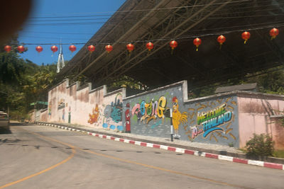 Illuminated street lights on road in city