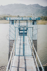 Pier over lake against sky