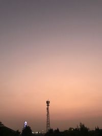 Silhouette tower and buildings against sky during sunset