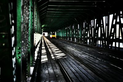 Railroad tracks seen through bridge