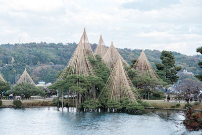 Scenic view of river by buildings against sky
