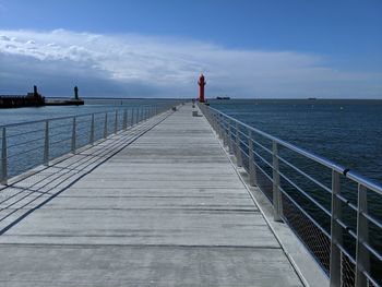 Pier over sea against sky