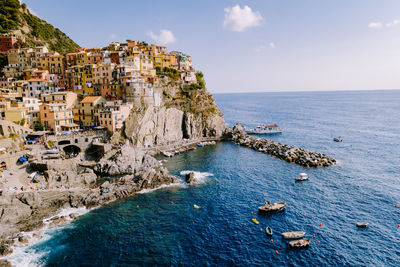 Panoramic view of sea and buildings against sky