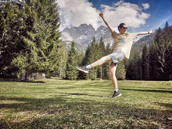 Full length of man jumping on tree