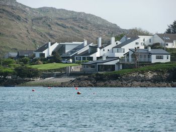 Scenic view of house on riverbank