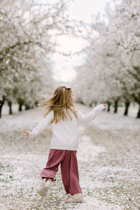 Preschool girl dancing in an almond orchard