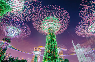 Low angle view of illuminated ferris wheel at night