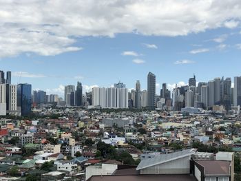 Aerial view of modern buildings in city against sky