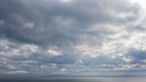 Scenic view of sea against storm clouds