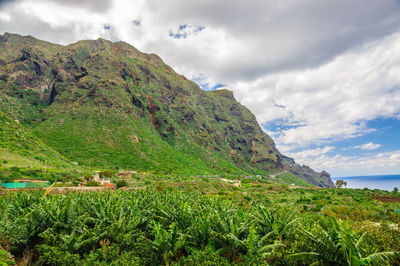 Scenic view of sea and mountains against sky