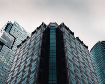 Low angle view of modern glass building against sky